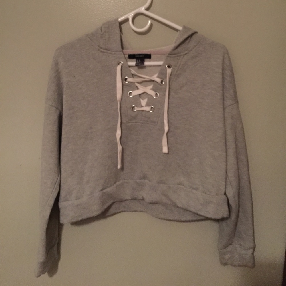A cropped hoodie with criss cross in the front